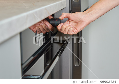 Female choosing program on electric oven panel Female choosing program on electric oven panel 96908184