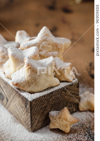 Homemade Christmas shortbread star shape cookies with powdered sugar in wooden box 96909888