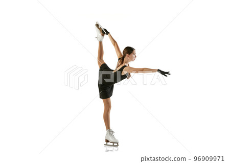 Young teen girl, junior female figure skater in black stage costume skating isolated over white background. Concept of skills, sport, beauty, winter sports 96909971