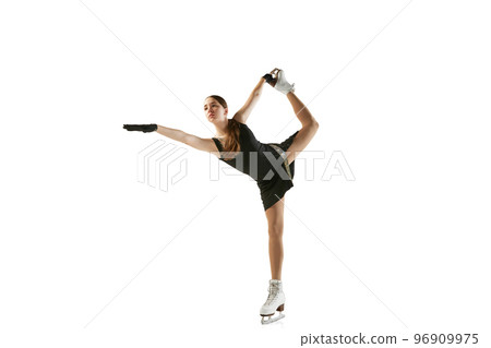 Studio shot of beautiful female figure skater in black festive stage dress practicing base elements of short program. Winter sports, flexibility, beauty 96909975