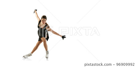 Portrait of flexible young girl, female figure skater in black stage costume skating isolated over white background. Junior athlete in motion. Sport, beauty, winter sports 96909992