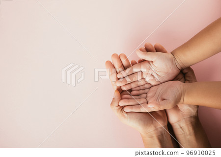 Close up hands children on adult mother hand, Top view person kid stack mom palms, Parents and little kid holding empty hands together isolated on pink background, Family day care concept 96910025