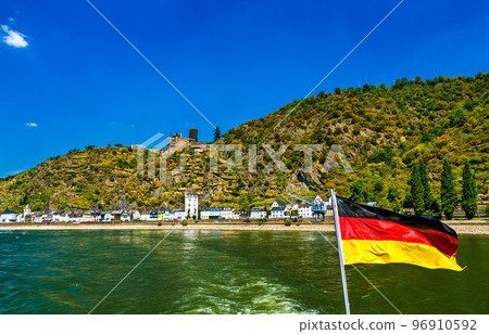 Katz Castle and Sankt Goarshausen seen from a cruise boat on the Rhine with a German flag Katz Castle and Sankt Goarshausen seen from a cruise boat on the Rhine with a German flag 96910592
