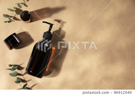 Natural cosmetic products, Zero waste, eco friendly bathroom accessories on beige background with leaves shadows 96912040