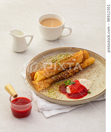Sweet crepe roll with cream and jam 96912301