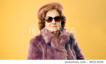 Modern and fashion older woman looking to camera Modern and fashion older woman looking to camera 96913699