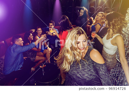 Party, dancing and drinks with people, crowd and women with alcohol for birthday, happy hour or new year celebration at nightclub, event or club. Friends celebrate with cocktails and fun energy 96914726