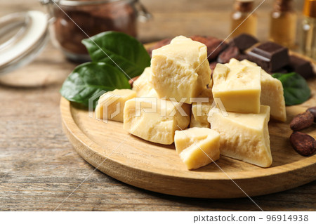 Organic cocoa butter on wooden table, closeup Organic cocoa butter on wooden table, closeup 96914938