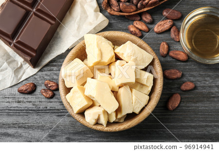 Flat lay composition with organic cocoa butter on black wooden table 96914941