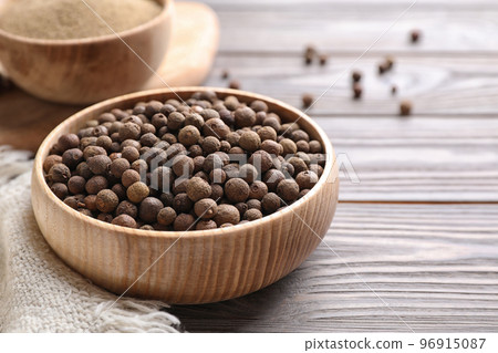 Peppercorns on light grey wooden table, closeup 96915087