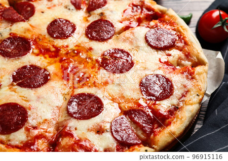 Hot delicious pepperoni pizza on table, closeup Hot delicious pepperoni pizza on table, closeup 96915116