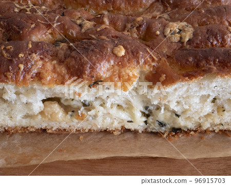 Freshly baked buttery, garlic-flecked bread. Soft crumb of parmesan garlic bread Freshly baked buttery, garlic-flecked bread. Soft crumb of parmesan garlic bread 96915703