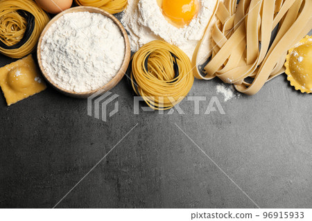 Flat lay composition with different types of pasta on grey table. Space for text Flat lay composition with different types of pasta on grey table. Space for text 96915933