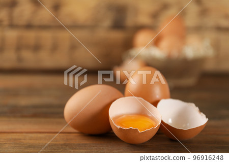 Raw brown chicken eggs on wooden table. Space for text Raw brown chicken eggs on wooden table. Space for text 96916248