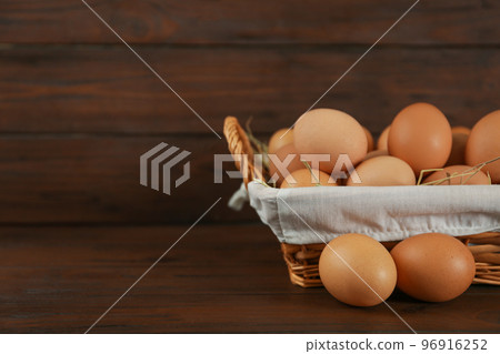 Raw chicken eggs on wooden table. Space for text 96916252