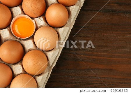 Raw chicken eggs on wooden table, top view. Space for text Raw chicken eggs on wooden table, top view. Space for text 96916285