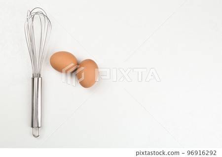 Raw eggs and whisk on white background, top view with space for text. Baking pie Raw eggs and whisk on white background, top view with space for text. Baking pie 96916292