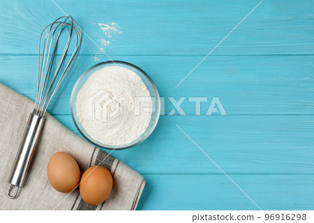 Flat lay composition with raw eggs on light blue wooden table, space for text. Baking pie Flat lay composition with raw eggs on light blue wooden table, space for text. Baking pie 96916298