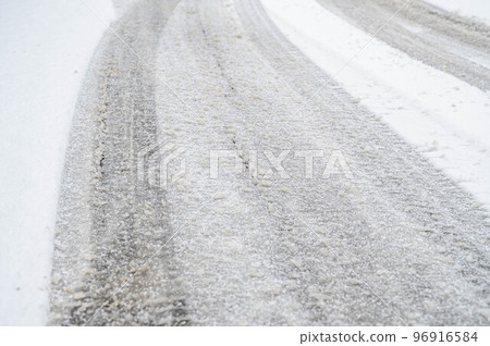 Snow day The snow begins to melt and harden on the road surface 96916584