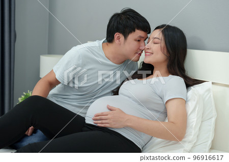 Husband kissing to pregnant wife and feeling happy 96916617