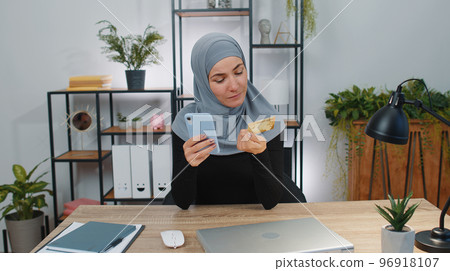 Business woman making online purchase payment shopping with credit bank card, smartphone at office Business woman making online purchase payment shopping with credit bank card, smartphone at office 96918107