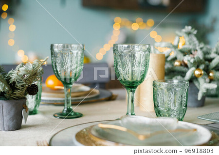Green glass glasses for a festive Christmas dinner Green glass glasses for a festive Christmas dinner 96918803