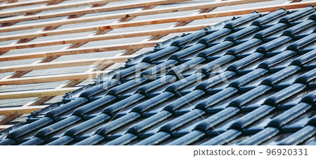 Black roof of burnt tiles reconstruction for the old house, building concept, expensive building material Black roof of burnt tiles reconstruction for the old house, building concept, expensive building material 96920331