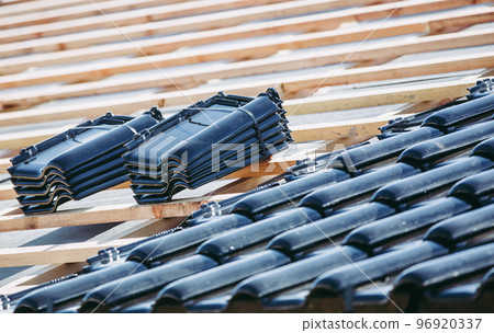 Black roof of burnt tiles reconstruction for the old house, building concept, expensive building material Black roof of burnt tiles reconstruction for the old house, building concept, expensive building material 96920337