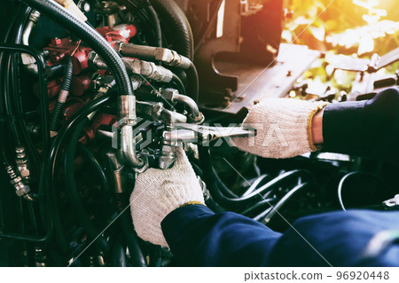 Close up view of hydraulic pipes of heavy industry machine. Low key. Hydraulic maintenance concept. 96920448