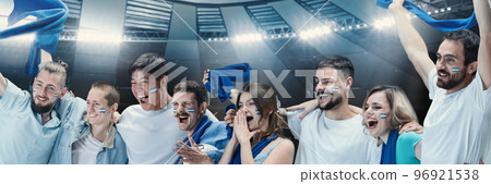 Group of emotive young people, football, soccer fans cheering their team at stadium. Happy winning emotions. Concept of sport, competition Group of emotive young people, football, soccer fans cheering their team at stadium. Happy winning emotions. Concept of sport, competition 96921538