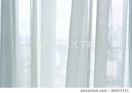Semi-transparent tulle on the window close up Semi-transparent tulle on the window close up 96923531