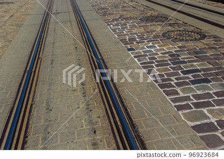 Metallic tracks in urban environment for tram. background image Metallic tracks in urban environment for tram. background image 96923684