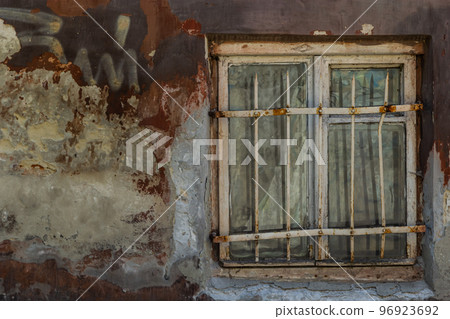 Old plaster wall and cracked brick background with vintage window Old plaster wall and cracked brick background with vintage window 96923692