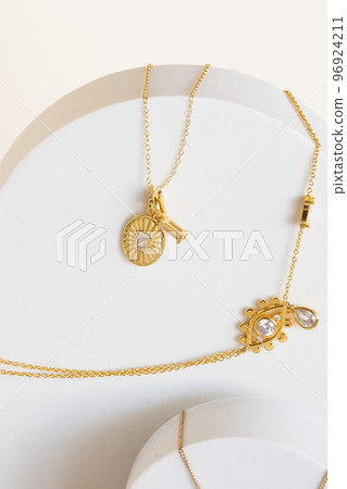 Golden necklaces on jewelry display stands. Golden necklaces on jewelry display stands. 96924211