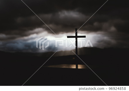 The cross of the suffering, death and resurrection of Jesus Christ with shining sky and clouds 96924858