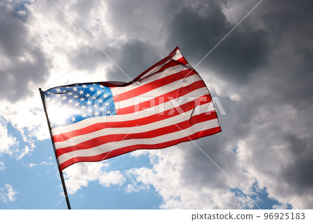 US American flag waving in stormy cloudy sky 96925183