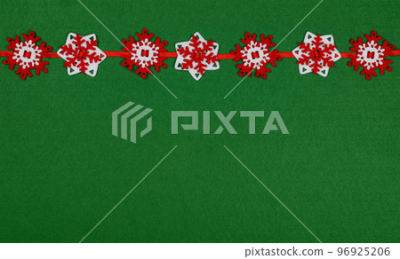 Red and white Christmas decoration over green Red and white Christmas decoration over green 96925206