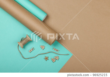 Packing Christmas gifts with blue and brown paper 96925215