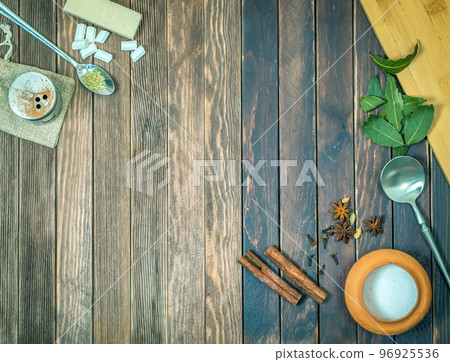 Old wood table with cinnamon, marshmallow, waffles, star anise, peppercorns, bay leaf, cloves. Background of wooden texture. Close-up pattern. Old wood table with cinnamon, marshmallow, waffles, star anise, peppercorns, bay leaf, cloves. Background of wooden texture. Close-up pattern. 96925536
