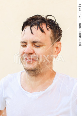 Young 32 years old european white male with closed eyes in water splash on yellow background. Man portrait, stress shock concept, mental health, rain, emotions, face expression, water drops. Young 32 years old european white male with closed eyes in water splash on yellow background. Man portrait, stress shock concept, mental health, rain, emotions, face expression, water drops. 96925614