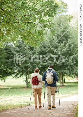 Couple Walking with Poles back View Couple Walking with Poles back View 96925698