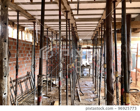 Slab shoring with eucalyptus wood and metal braces, commonly used in the construction of a house in Brazil Slab shoring with eucalyptus wood and metal braces, commonly used in the construction of a house in Brazil 96925773