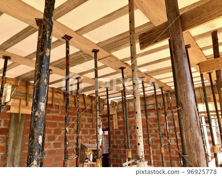 Slab shoring with eucalyptus wood and metal braces, commonly used in the construction of a house in Brazil 96925778