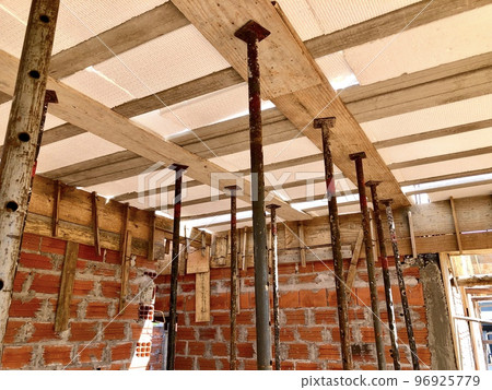 Slab shoring with eucalyptus wood and metal braces, commonly used in the construction of a house in Brazil Slab shoring with eucalyptus wood and metal braces, commonly used in the construction of a house in Brazil 96925779