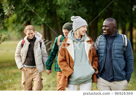 Group of friends enjoying walk in forest 96926369