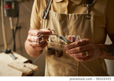 Artisanal jeweler creating handmade ring Artisanal jeweler creating handmade ring 96926495