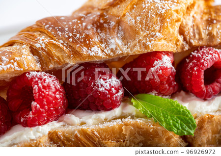 Croissant with fresh raspberries Croissant with fresh raspberries 96926972