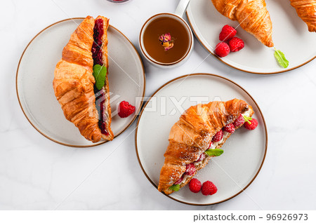 Croissant with fresh raspberries 96926973