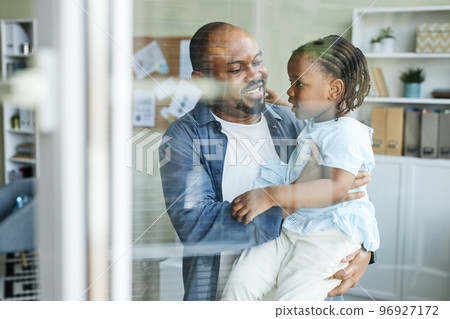 Happy father embracing cute child in office 96927172