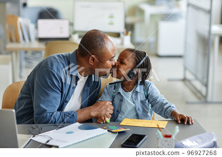 Father kissing daughter on Fathers day 96927268